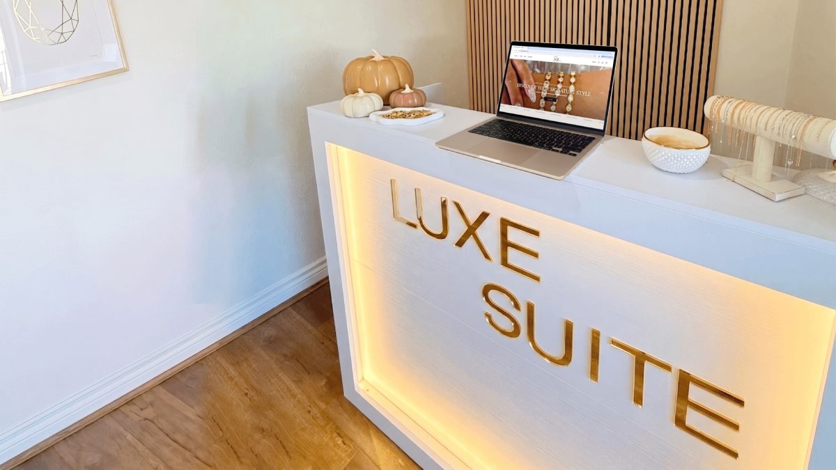 The boutique's counter with its lit Luxe Suite sign